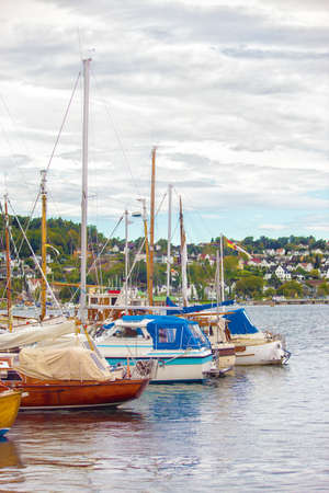 Boats and yachts tied up with ropes to a pier.Norway, Sandefjord.の写真素材
