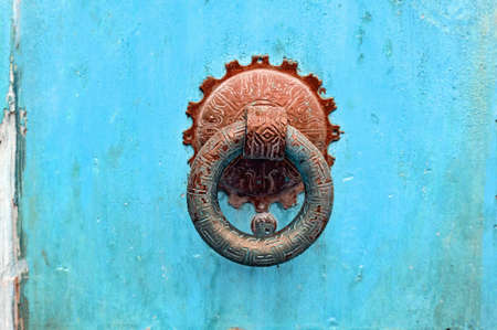 Knocker ring on an old blue painted door. Close up.の写真素材
