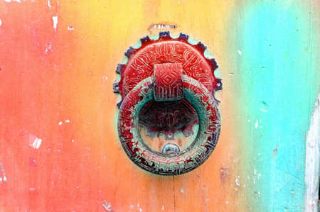Knocker ring on an old colorful painted door. Close up.の写真素材