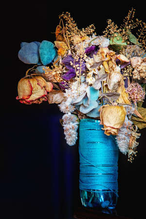 Colorful dried flowers bouquet in a blue vase. Close up.の写真素材