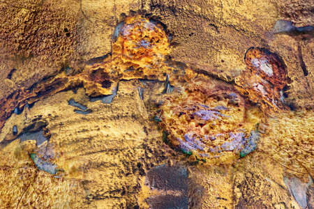 Old colorful polyurethane foam on rusty metallic surface. Close up. For background.