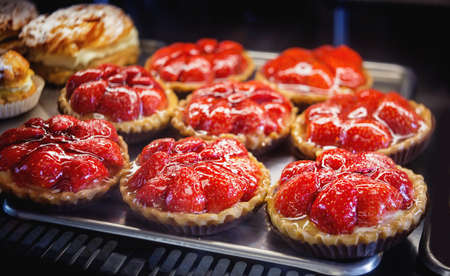 Cakes with strawberries on a metal tray. Close up.の写真素材