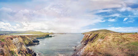 Panoramic landscape with a rocky ocean shore in a southwest Ireland. Bray Head Car Park.