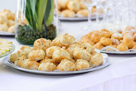 Cakes with sesame in a plate on a buffet table. Close up.
