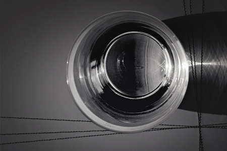 Glass of water on the table with reflections on it. Close up. Top view.