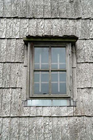 Wooden window on an ancient wooden chip windmill in Lazdininkai. Lithuania.