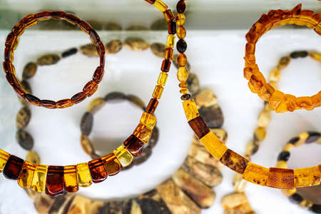 Amber neklaces and bracelets on a white background. Close up.の写真素材