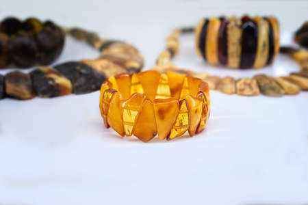 Amber neklaces and bracelets on a white background. Close up.