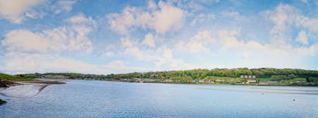 Courtmacsherry village across the harbour at low tide. County Cork, Ireland.