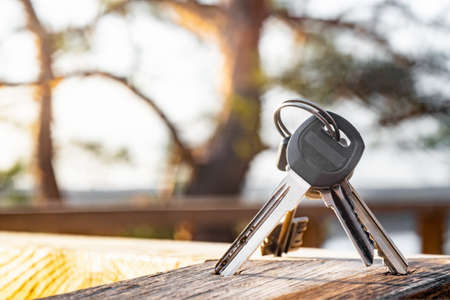 Various keys with ring on a wooden board. Close view.の写真素材