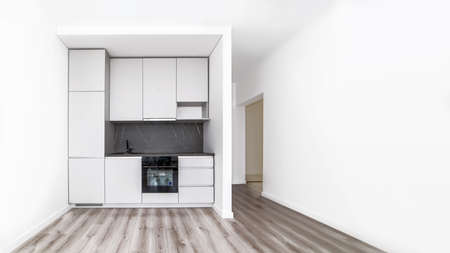 White dining room with kitchen corner in house. Space for text.の写真素材
