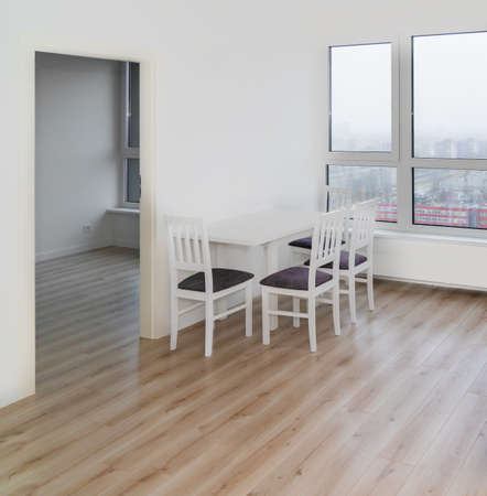 White table and chairs in a white living room