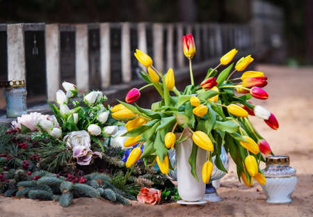 Tombstones, natural and artificial flowers on tombs of warriors. Lithuania, Kaunas
