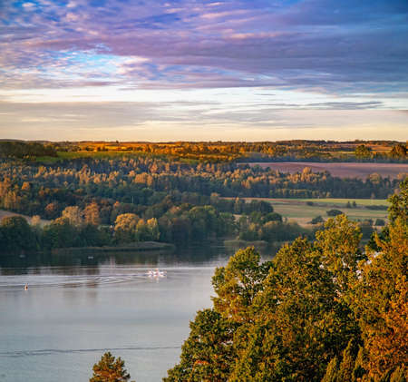 White floatplane lands on the lake in the fall