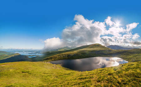 Panoramic view of Devils Punch Bowl lake on Mount Mangerton in the morning. Ireland, County Kerry,...
