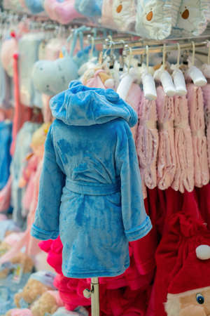 Blue terry bathrobe in a shop window. Close view.の写真素材