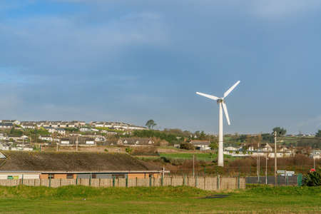Small windmill on sunny morning . Claycastle Bay Beach, county Cork, Ireland.