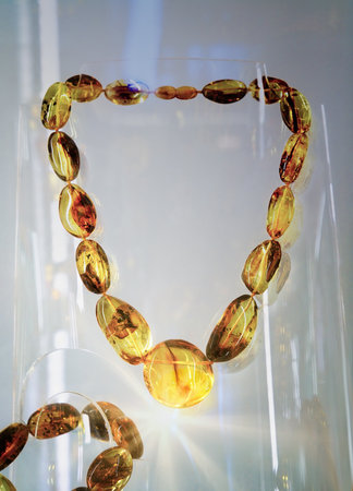 Amber beads on the glass shelf. Close up.の写真素材