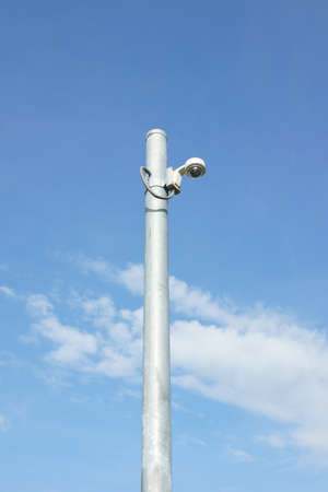 Security cctv camera against blue skyの写真素材