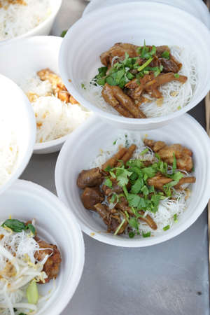 noodles with vegetables and chicken in bowl preparing for sale - Thailand marketの写真素材