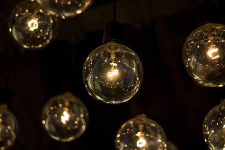 electric lamps hanging on the ceiling in the dark room
