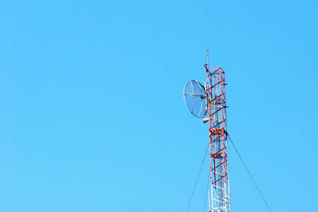 Telecommunication tower against blue skyの写真素材