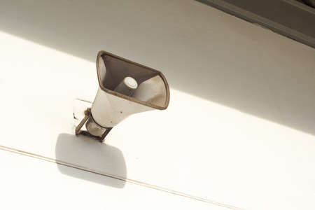 an old loudspeaker under the roofの写真素材