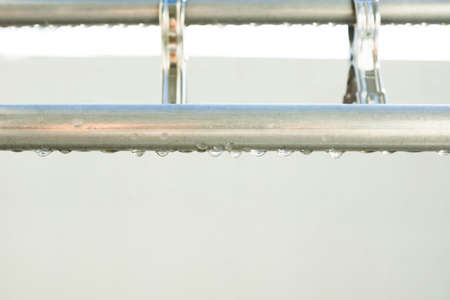 Metal clothesline after rainの写真素材