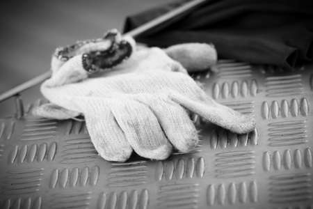 Work Gloves on checkered steel plate - Black and Whiteの写真素材