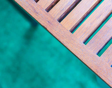 Part of Wooden slats table on blurry green turf for background and frame  - Retro styleの写真素材