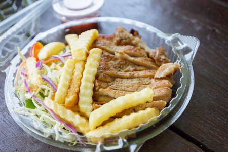 Pork steaks in a plastic box for take home. - Thailand street foodの写真素材
