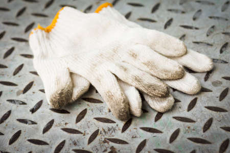 Work gloves on metal sheetの写真素材