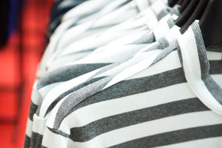 Cloth Hangers with Colorful T-Shirts as abstract backgroundの写真素材