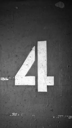 Spray painted of character 4 on old cement wall - Black and Whiteの写真素材