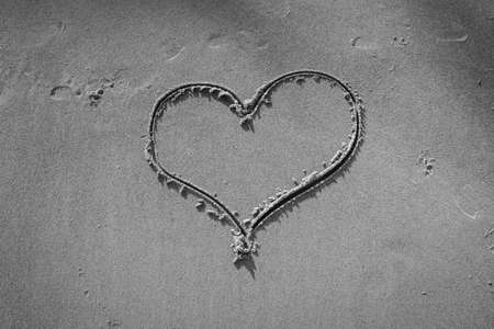 Heart drawn in the sand on Beach background - Black and Whiteの写真素材