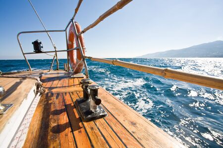 summer series: modern wooden yacht in the sea. Deck view