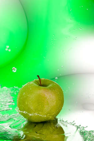 ripe green apple over abstarct blue backgroundの写真素材