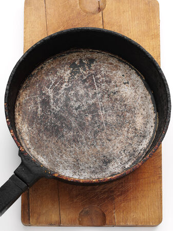 old style frying pan on wooden plankの写真素材