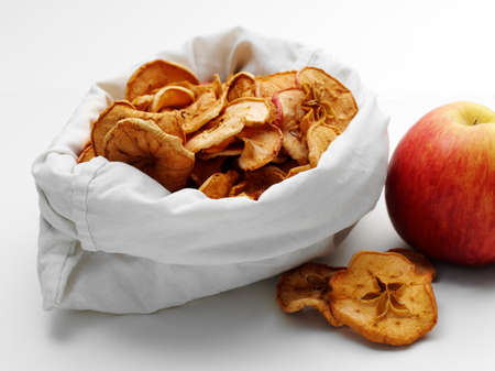 dried apples in the bag with fresh ripe onesの写真素材
