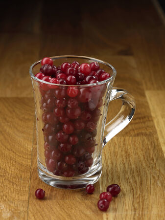 Cranberry glassy cup on the wooden tableの写真素材