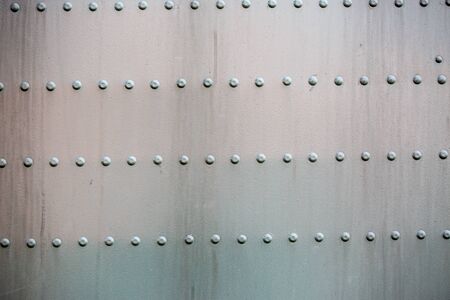 Old gray steel riveted surfaceの写真素材