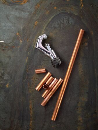 Tube cutter with copper pipes on steel plateの写真素材