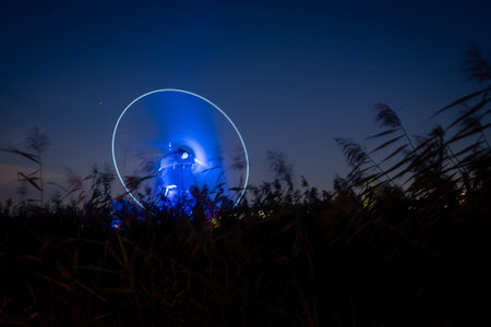 Night view of the silhouette of a man in the middle of the field.の写真素材