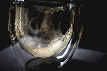 Coffee in a glass cup on a black background. Close-up.の写真素材