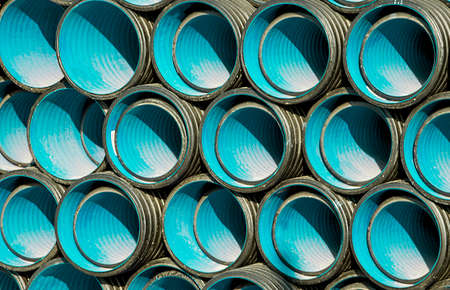 PVC pipes staked in construction siteの写真素材