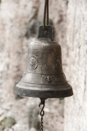 Detail of aged bell on a stone made monastery in Greece