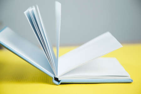opening notepad on the yellow backgroundの写真素材