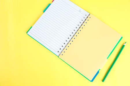 notepads with pencil on the yellow backgroundの写真素材