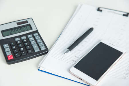 phone with calculator on document on the deskの写真素材
