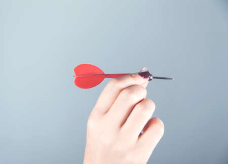 woman hand arrow trget on gray wall backgroundの写真素材